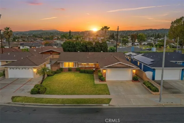 an aerial view of residential houses with outdoor space and city view
