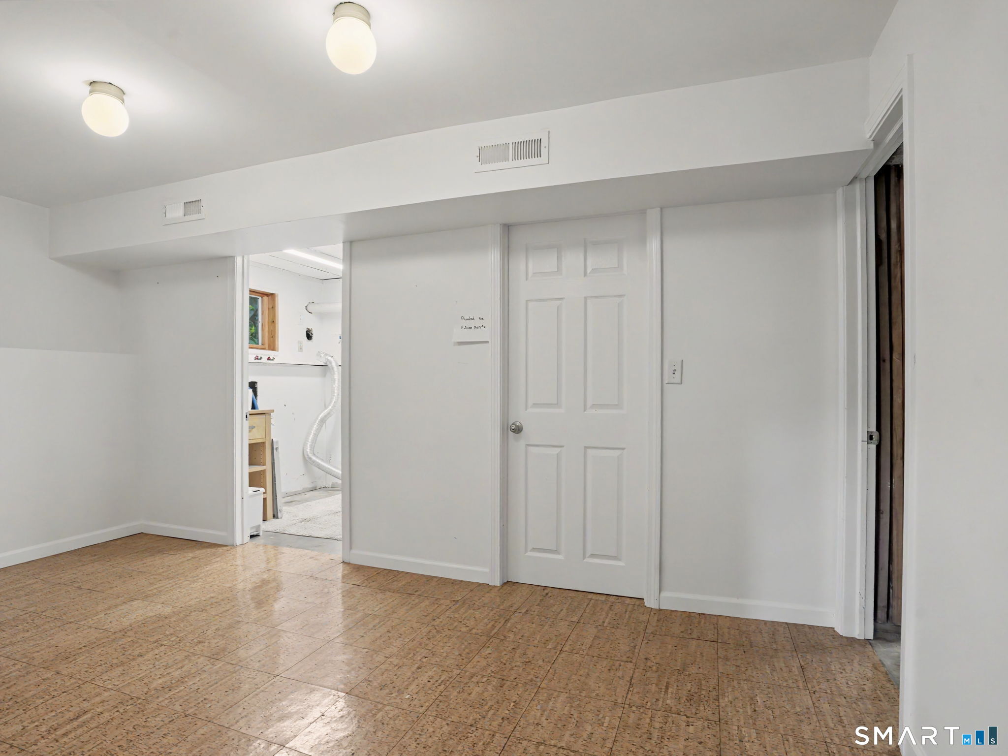 26 Abbott Avenue Ridgefield, CT 06877 - Photo 40 of 40 This empty room was used as a playroom but could be bedroom for ADU as mentioned above. Laundry room is through open door. Closed door is a possible 4th bathroom that has been plumbed. Floor plans can be viewed under documents in MLS