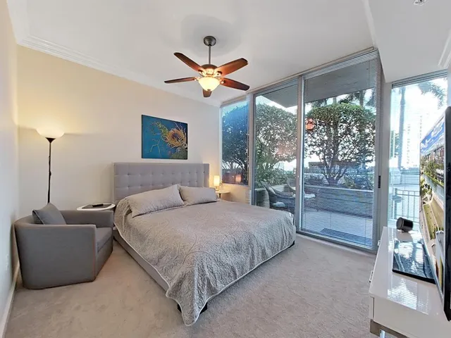 a bed room with a bed and a large window