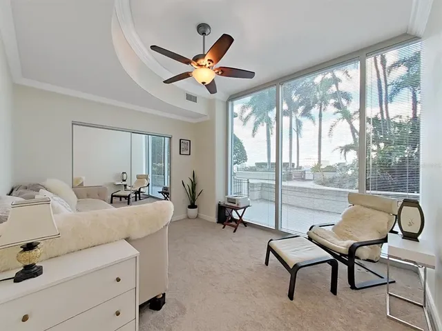 a living room with furniture a flat screen tv and a large window