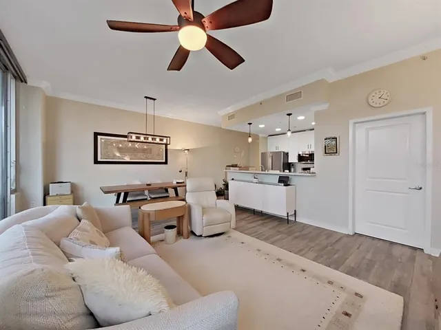 a living room with furniture and a chandelier
