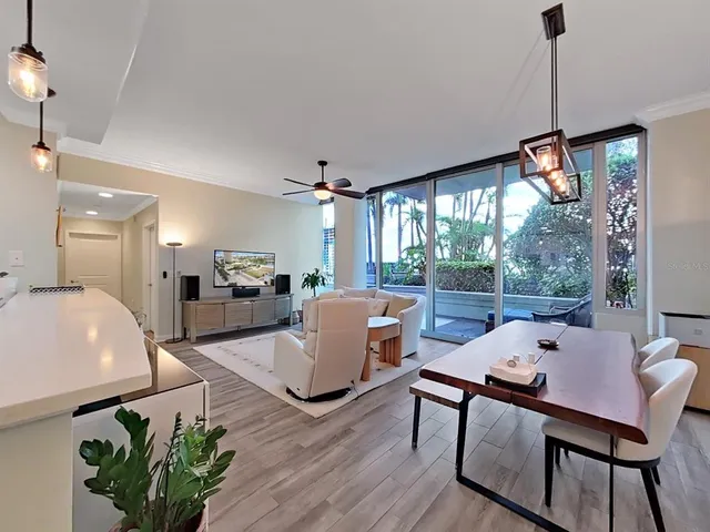 a kitchen with kitchen island a counter top space a sink a refrigerator and a stove