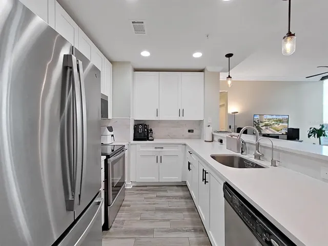 a kitchen with a stove a refrigerator and a microwave