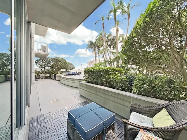 a view of a porch with chairs and backyard