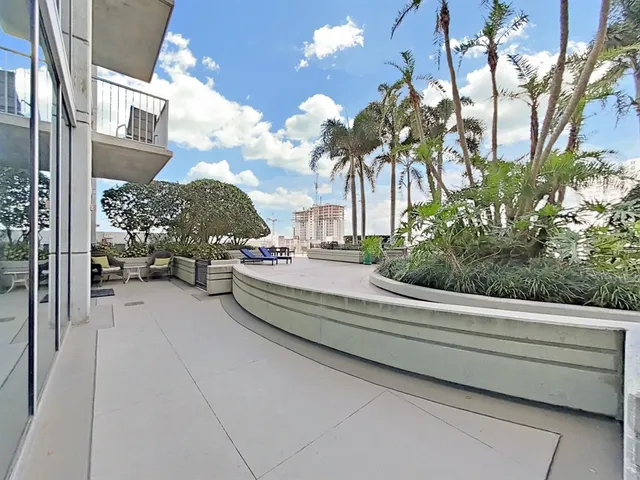 a view of roof deck with couches and city view