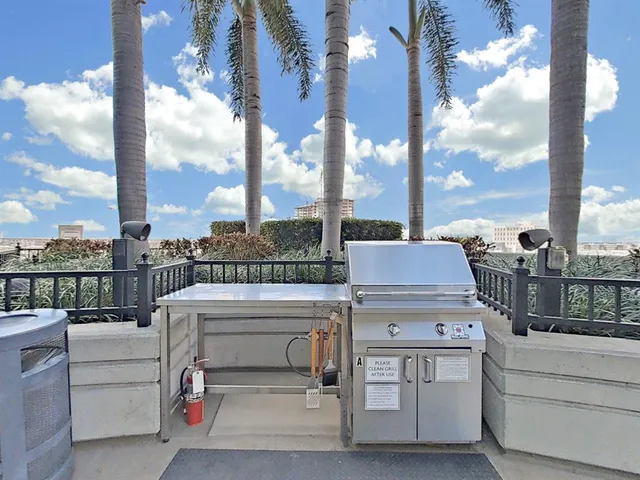 a living room with furniture a table and a large window