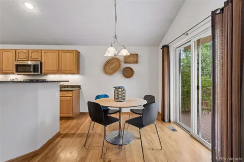 a dining room filled chandelier and wooden floor