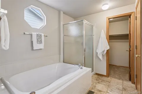 a bathroom with a tub and a shower