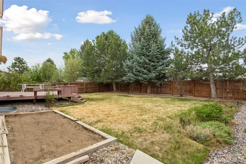 a view of a backyard with swimming pool