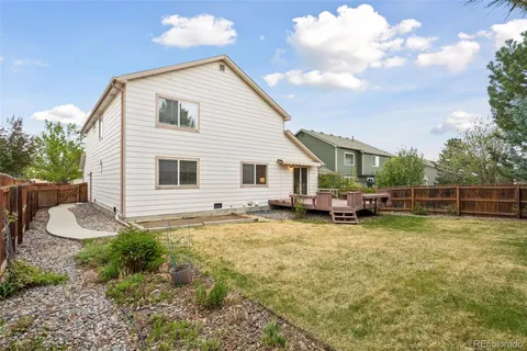 a view of a house with backyard porch and sitting area