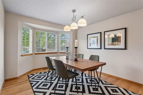 a view of a dining room with furniture window and wooden floor