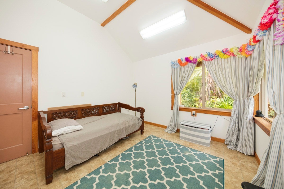 19-3882 Old Volcano Road Volcano, HI 96785 - Photo 19 of 30 a bedroom with a bed and a window