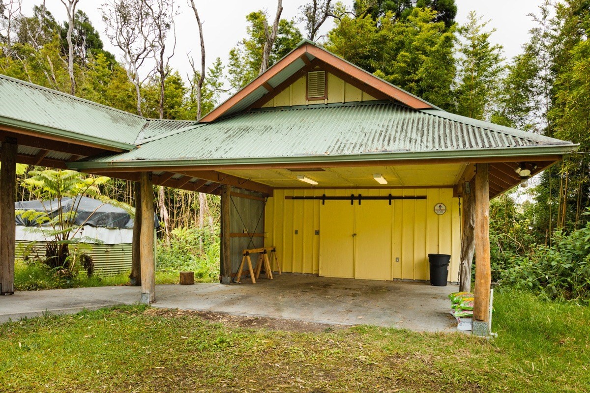 19-3882 Old Volcano Road Volcano, HI 96785 - Photo 3 of 30 a front view of a house with a yard and garage