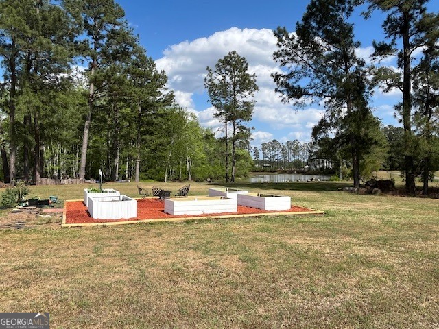 4338 Union Road Metter, GA 30439 - Photo 20 of 26 a view of a swimming pool with an outdoor space and seating area