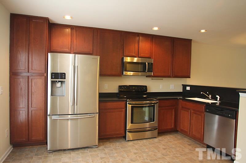 This Kitchen is equipped with stainless steel appliances and solid surface counter tops with breakfast bar.
