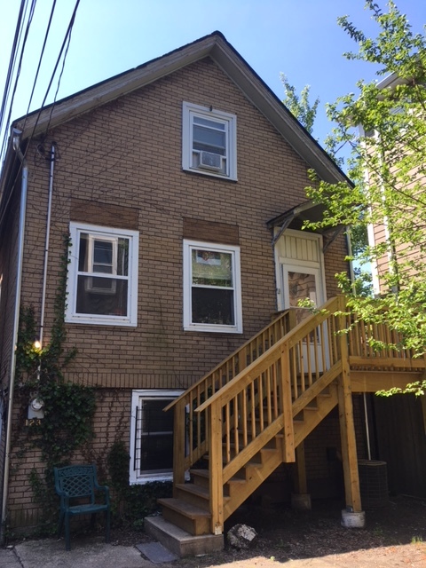 1237 West Wellington Avenue, Unit CH Chicago, IL 60657 - Photo 1 of 1 a view of a house with wooden fence and two windows