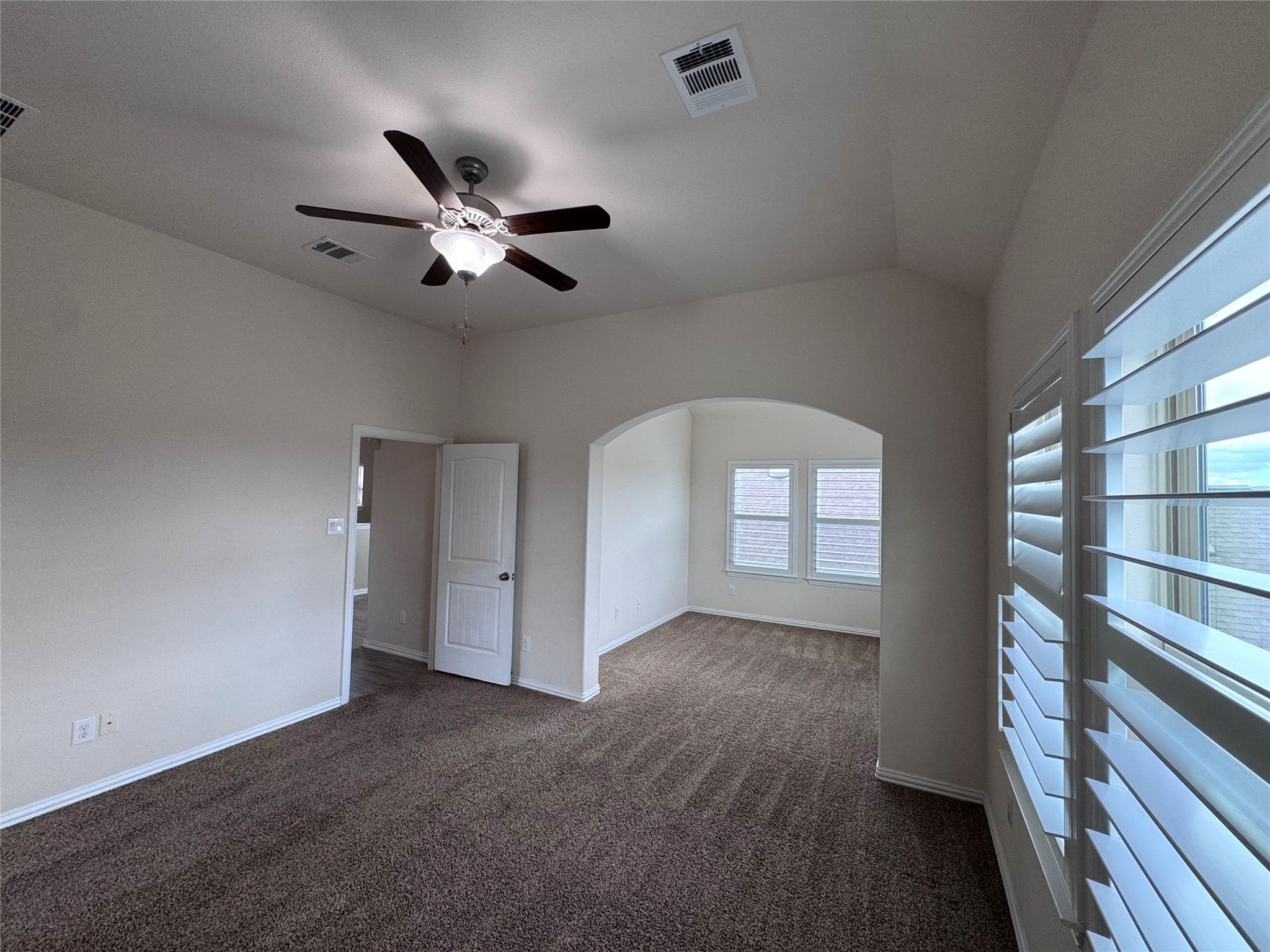 2605 Rough Berry Road Pflugerville, TX 78660 - Photo 31 of 40 A versatile room features a vaulted ceiling, plush carpeting, and elegant plantation shutters.