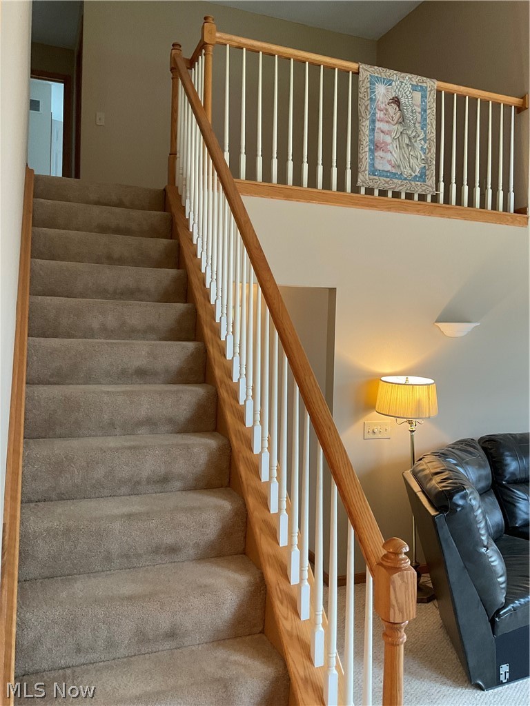8603 Murray Road Cleveland, OH 44125 - Photo 10 of 26 Staircase featuring light carpet