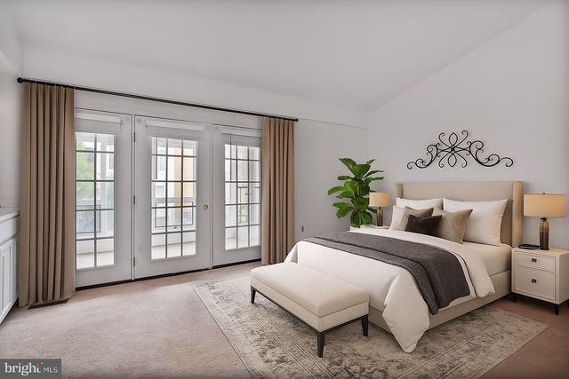 a bedroom with a large bed and a window