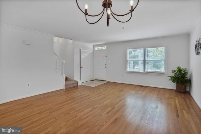 a view of a room with wooden floor and entryway