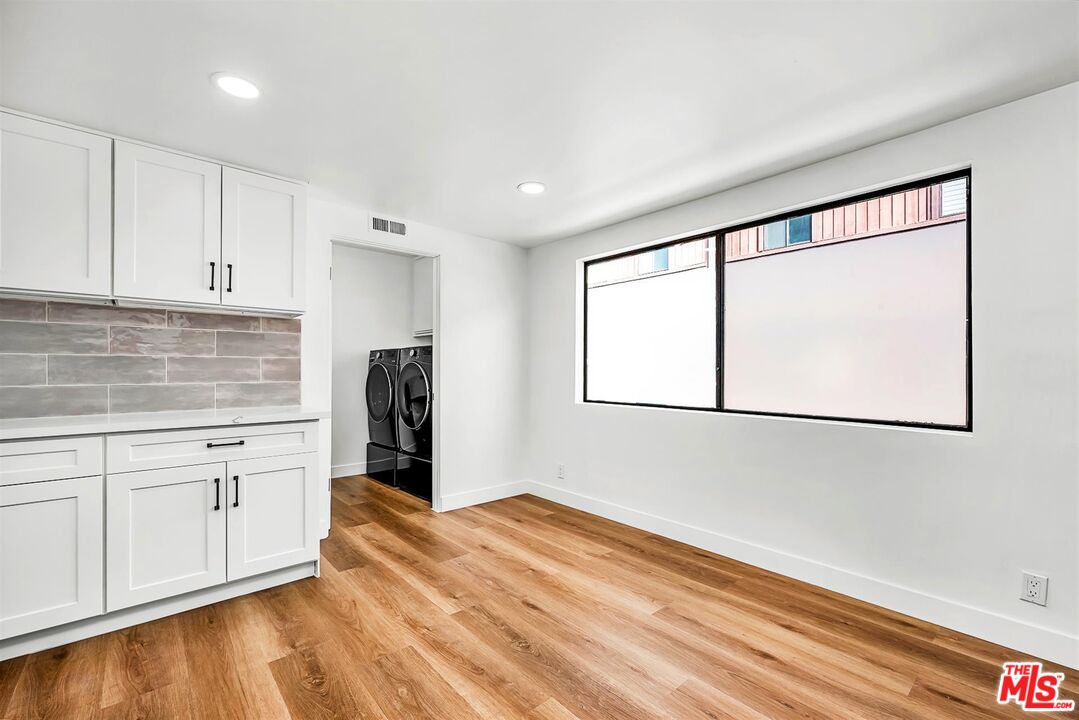 4425 Alla Road, Unit 5 Marina del Rey, CA 90292 - Photo 12 of 30 a kitchen with granite countertop white cabinets and refrigerator