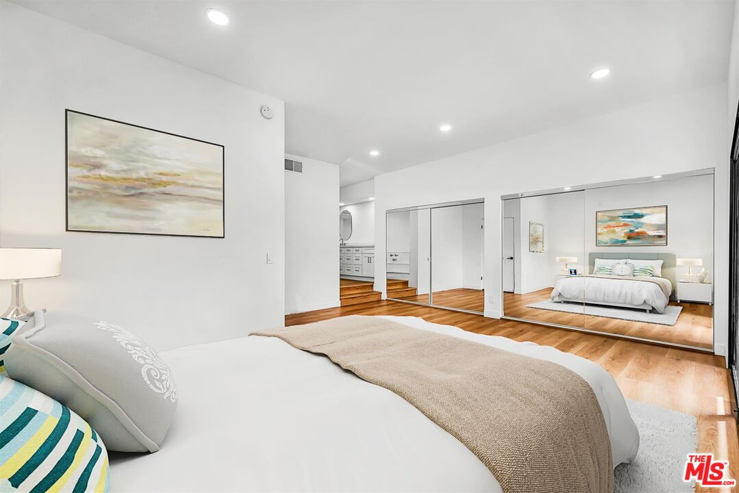 4425 Alla Road, Unit 5 Marina del Rey, CA 90292 - Photo 17 of 30 a spacious bedroom with a bed and glass walk in closet
