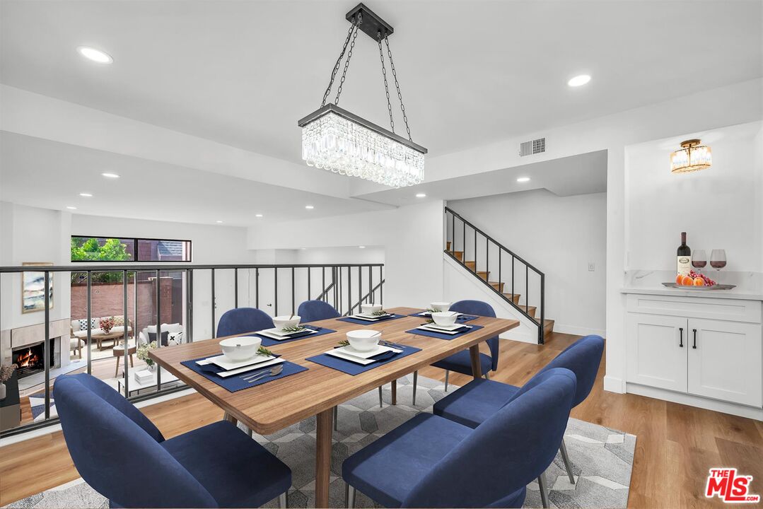 4425 Alla Road, Unit 5 Marina del Rey, CA 90292 - Photo 9 of 30 a living room with furniture a rug and a chandelier