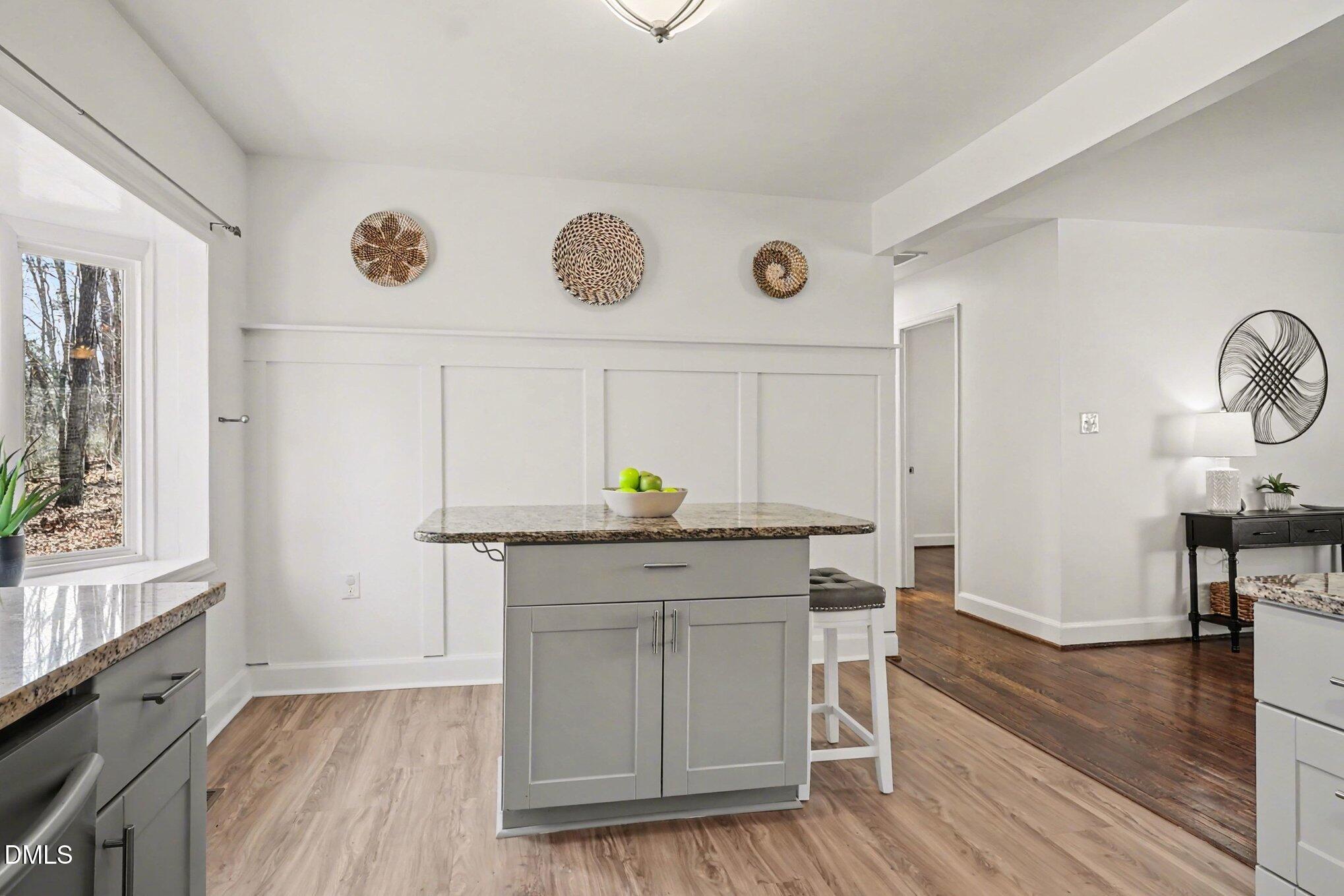 3043 Creech Road Garner, NC 27529 - Photo 10 of 38 a kitchen with granite countertop white cabinets and wooden floor