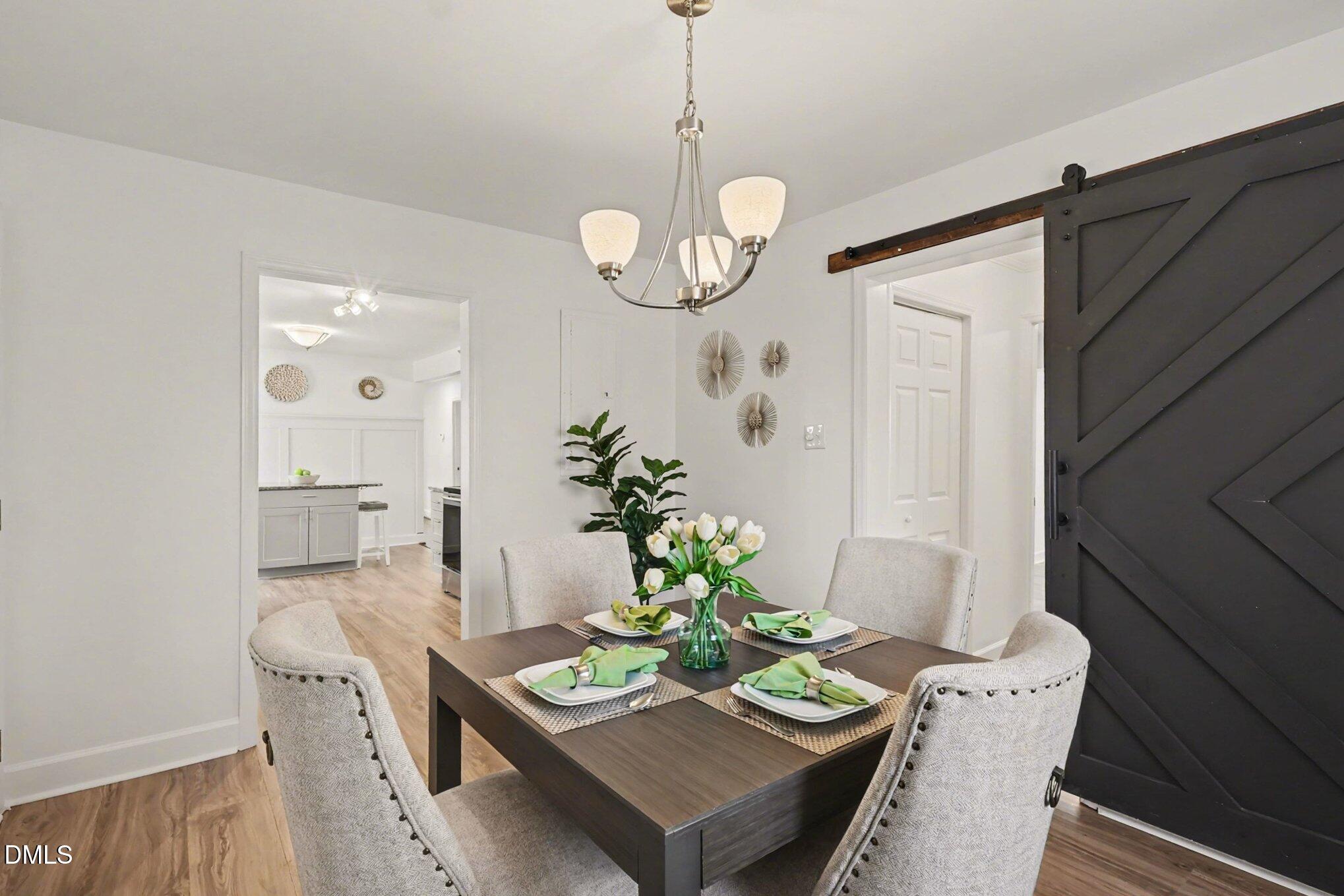 3043 Creech Road Garner, NC 27529 - Photo 12 of 38 a view of a dining room with furniture wooden floor and a chandelier