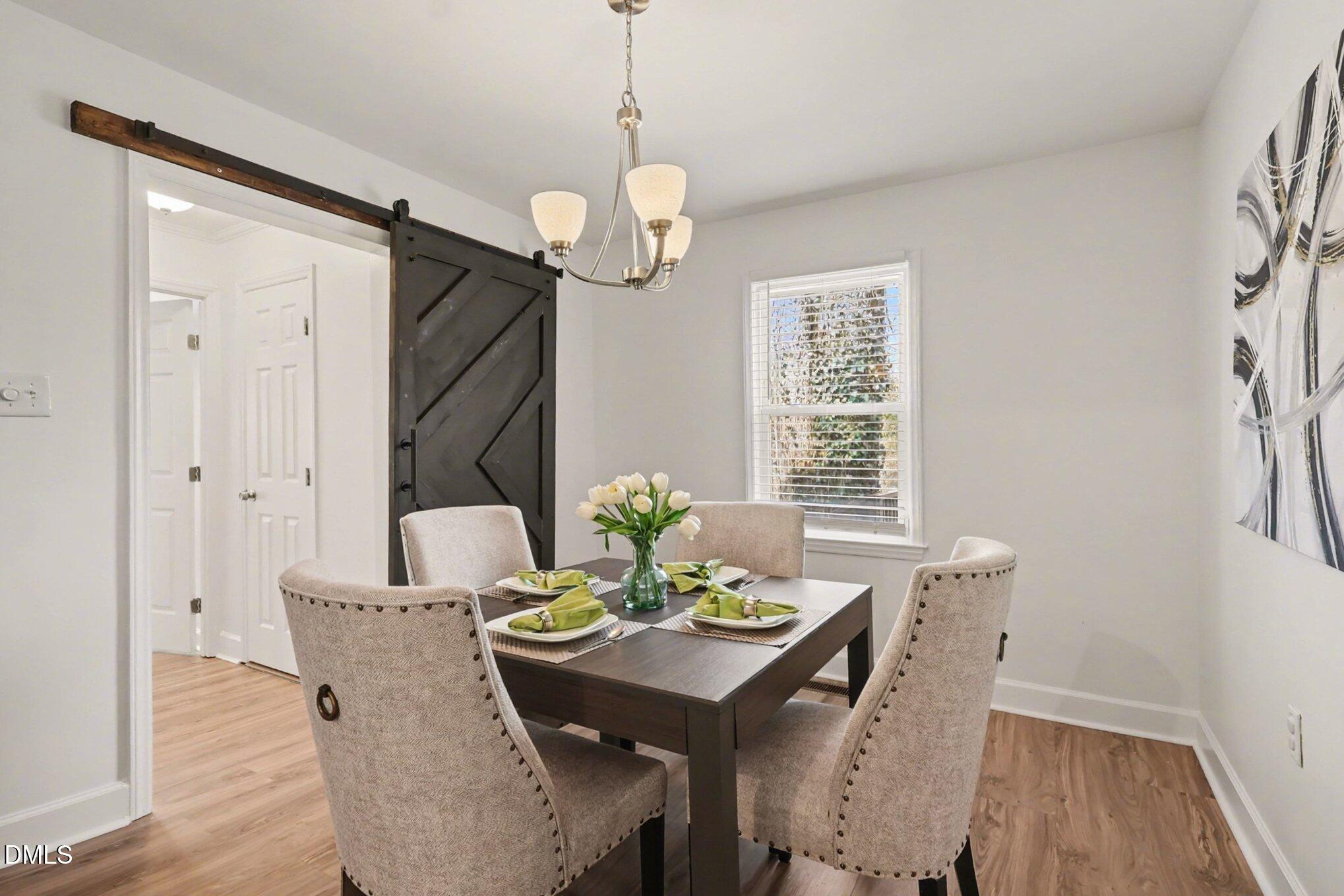 3043 Creech Road Garner, NC 27529 - Photo 13 of 38 a view of a dining room with furniture window and wooden floor