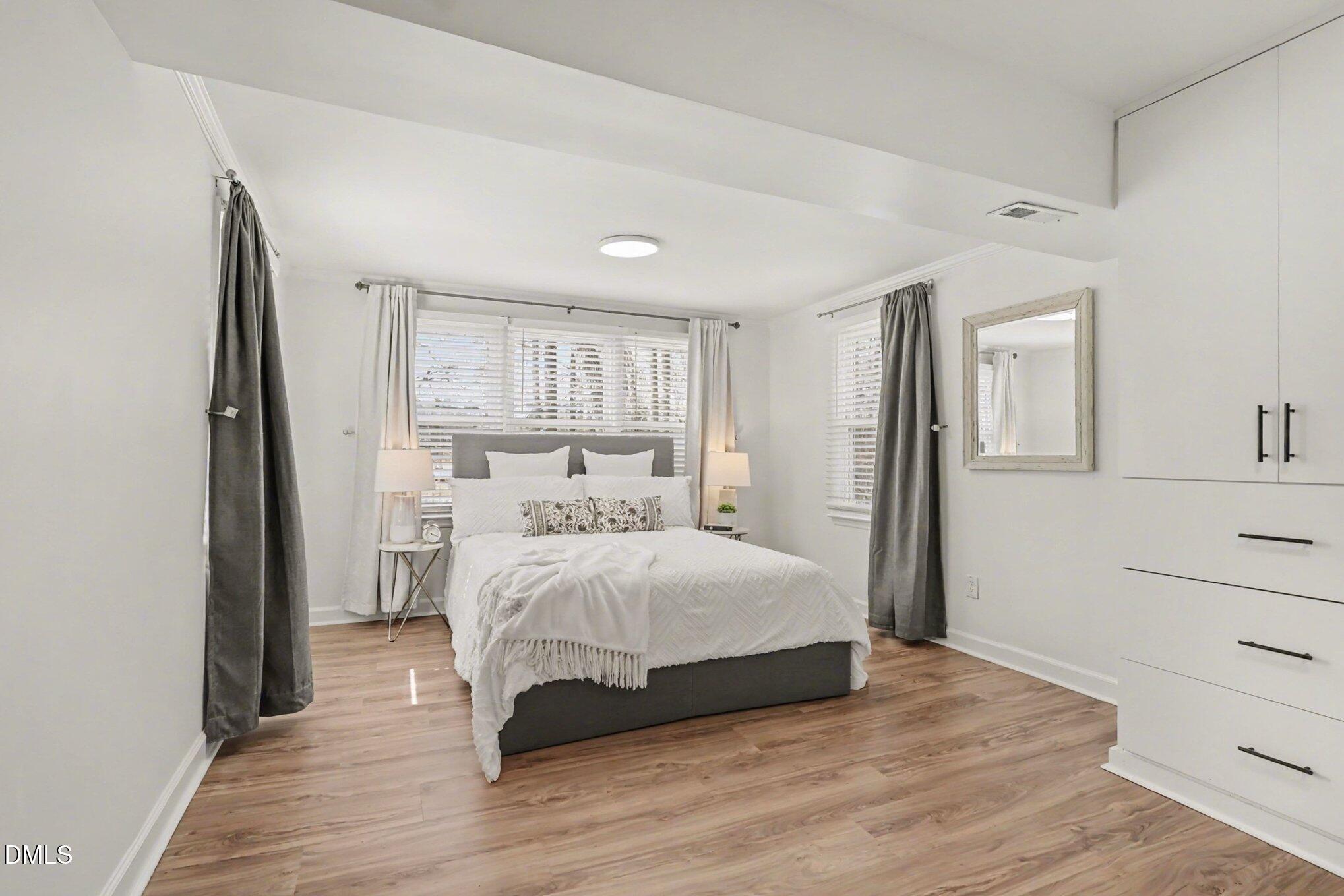 3043 Creech Road Garner, NC 27529 - Photo 15 of 38 a bedroom with a bed and a dresser