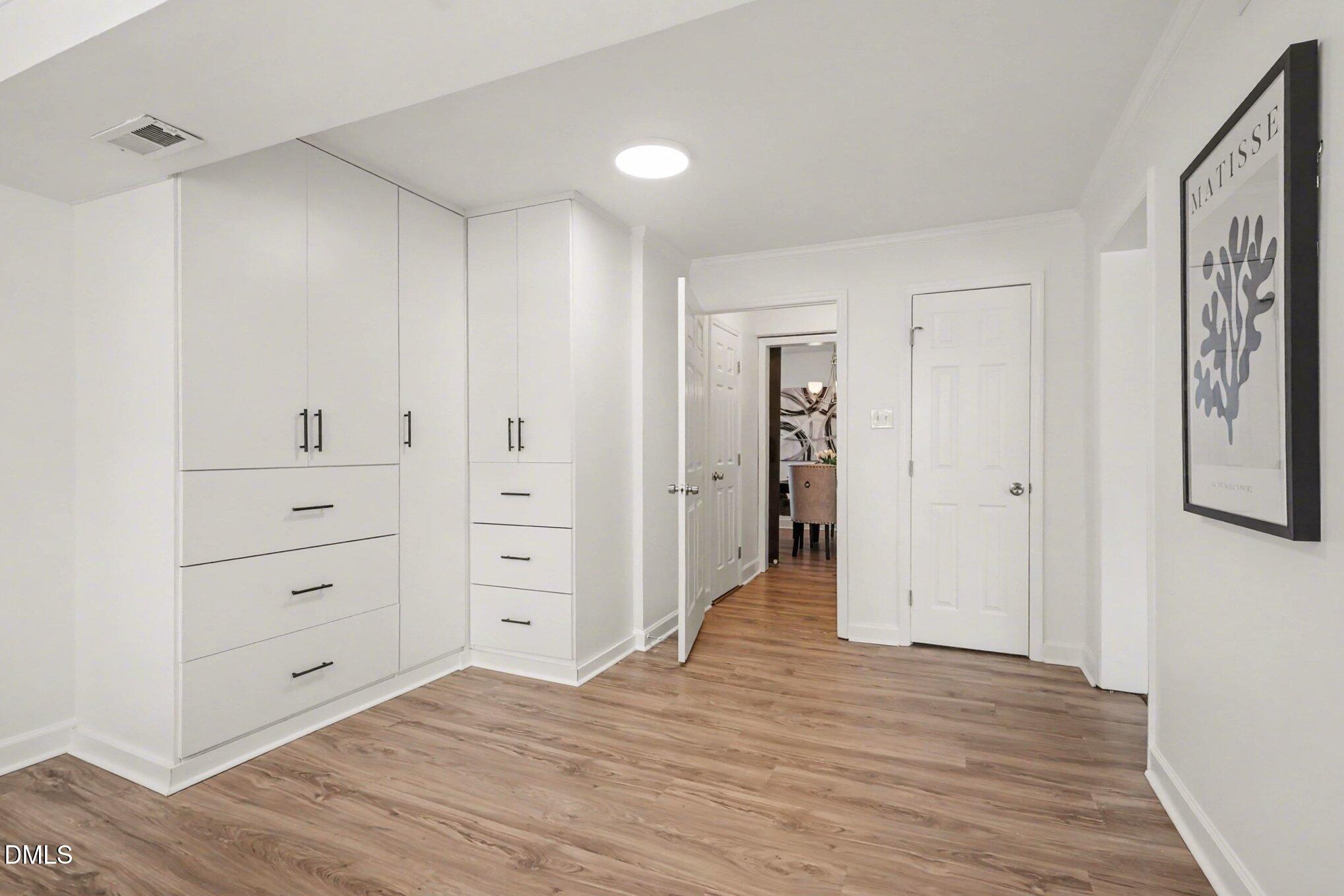 3043 Creech Road Garner, NC 27529 - Photo 16 of 38 wooden floor with white cabinet