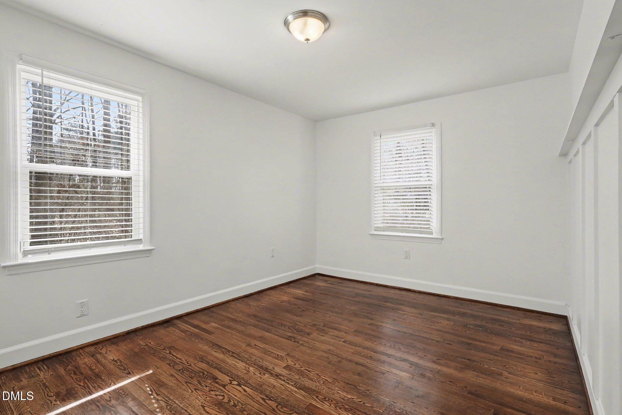 3043 Creech Road Garner, NC 27529 - Photo 19 of 38 a view of an empty room with wooden floor and a window
