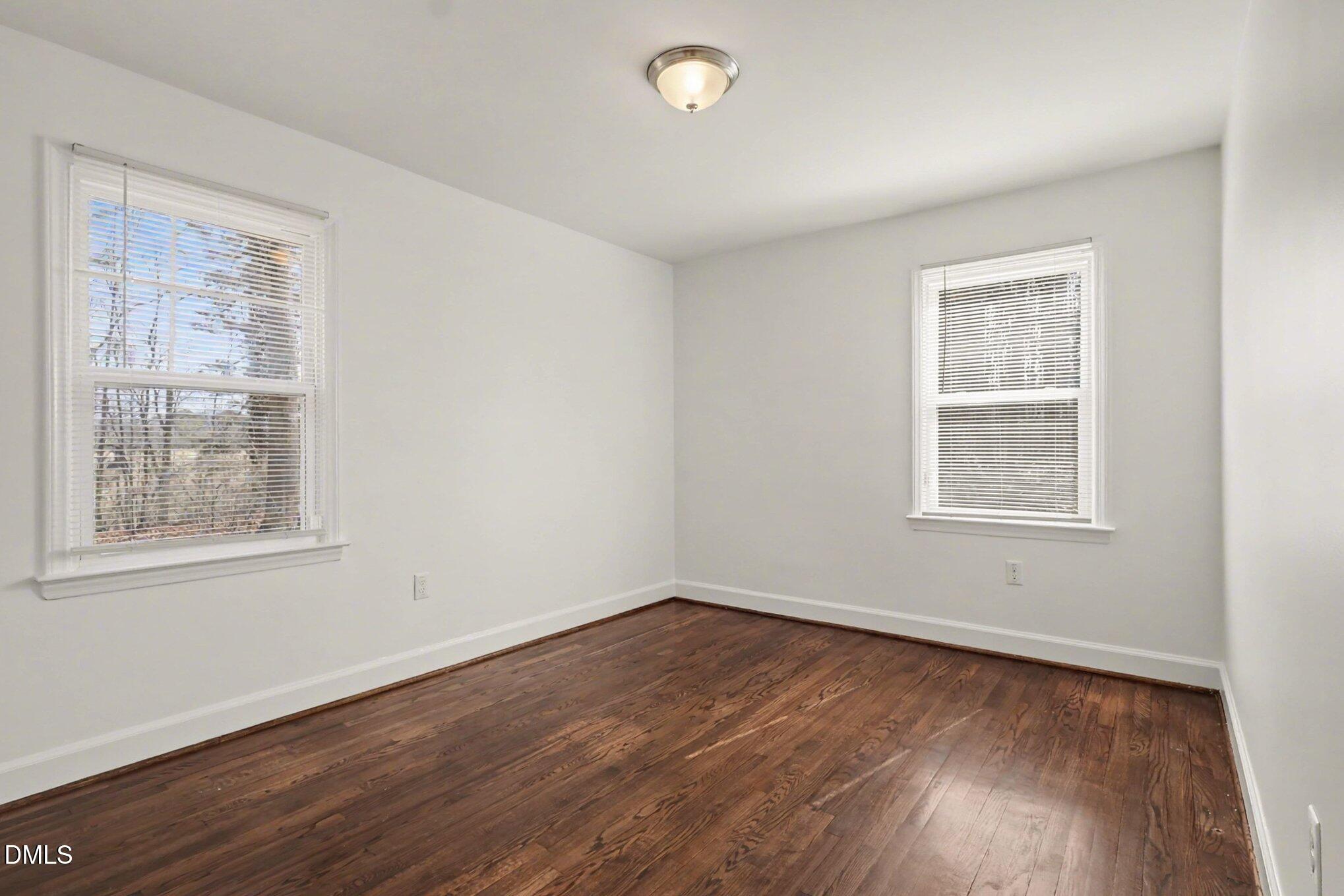 3043 Creech Road Garner, NC 27529 - Photo 21 of 38 a view of an empty room with wooden floor and a window