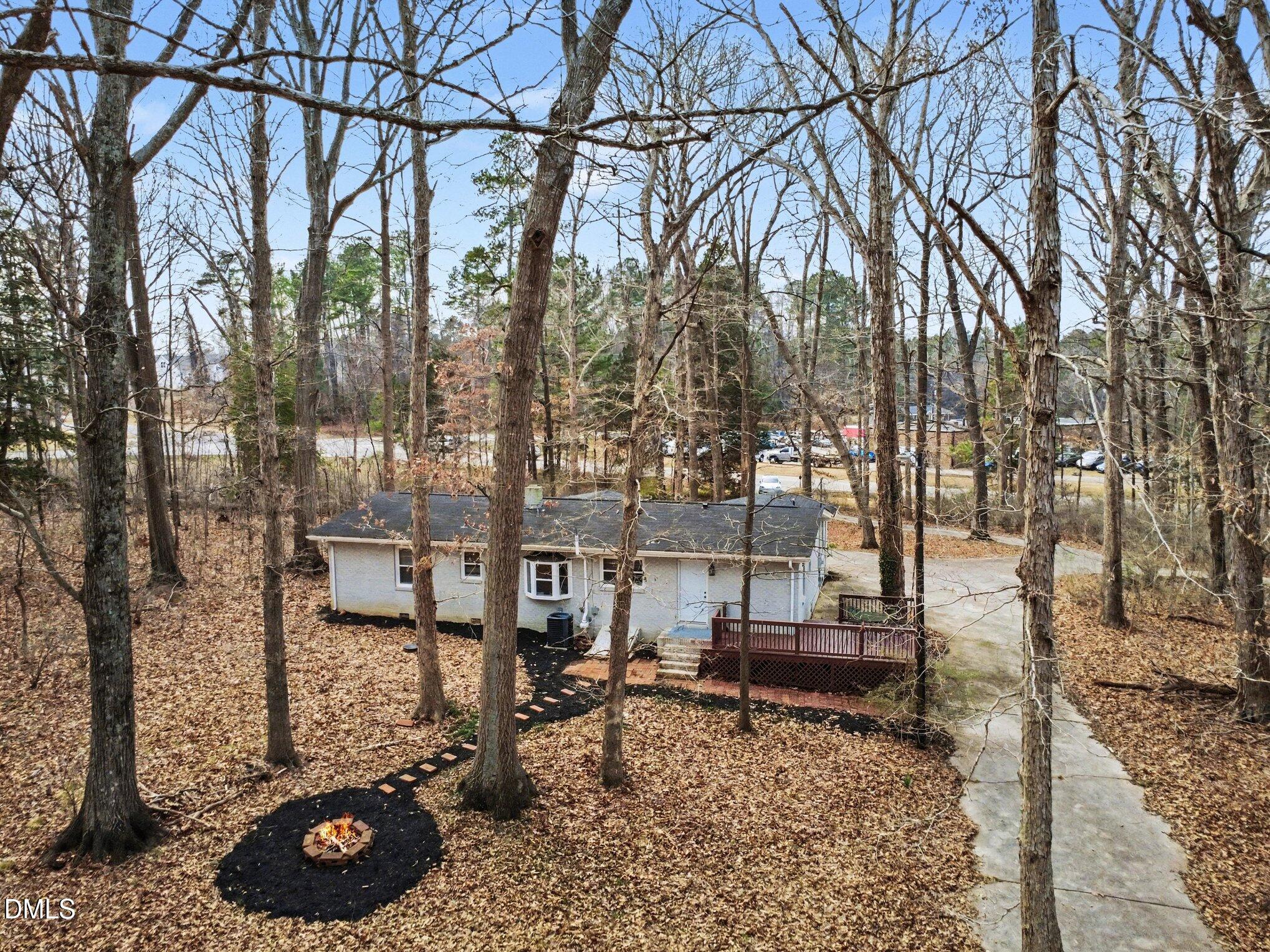 3043 Creech Road Garner, NC 27529 - Photo 26 of 38 a view of a backyard with table and chairs under an umbrella