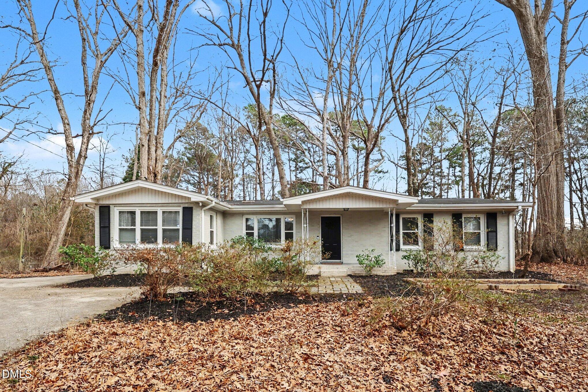 3043 Creech Road Garner, NC 27529 - Photo 32 of 38 a front view of a house with garden