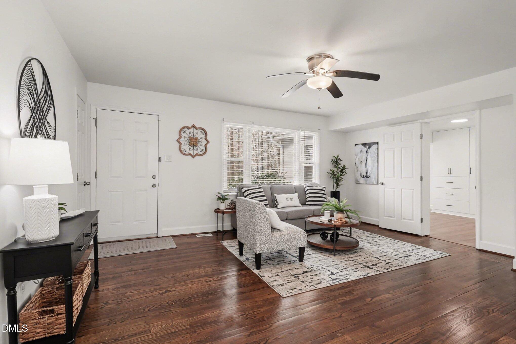 3043 Creech Road Garner, NC 27529 - Photo 5 of 38 a living room with furniture a window and wooden floor
