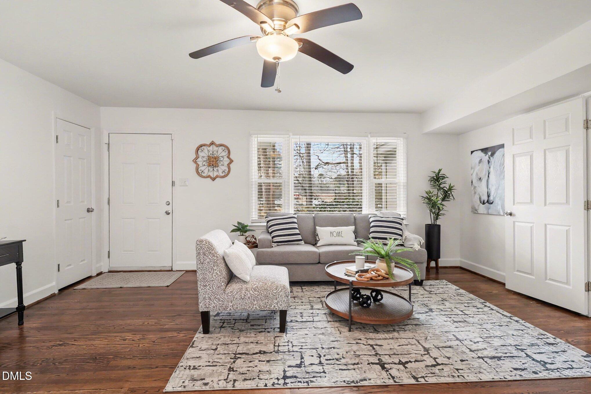 3043 Creech Road Garner, NC 27529 - Photo 6 of 38 a living room with furniture a rug and a chandelier