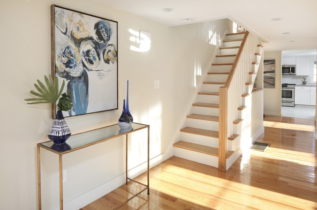 a view of entryway and hall with wooden floor