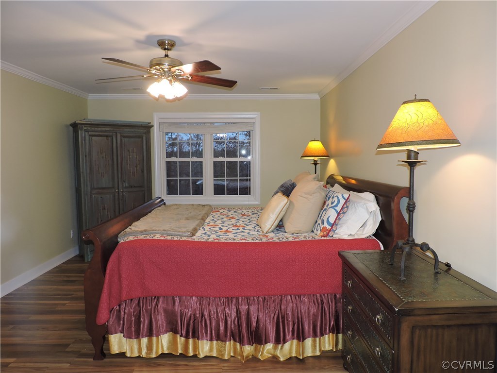 12201 Coalboro Road Chesterfield, VA 23838 - Photo 23 of 49 a bed room with a bed and a chandelier