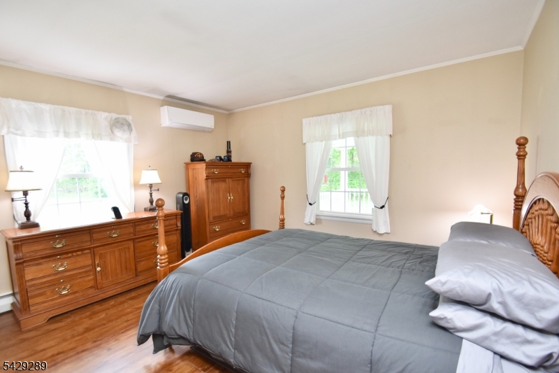 16 Pequot Trail Oak Ridge, NJ 07438 - Photo 7 of 18 a bedroom with a bed and wooden floor