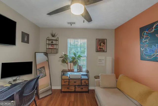 a reading room with furniture and a flat screen tv