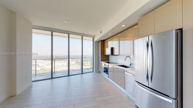 a kitchen with stainless steel appliances a refrigerator sink and cabinets