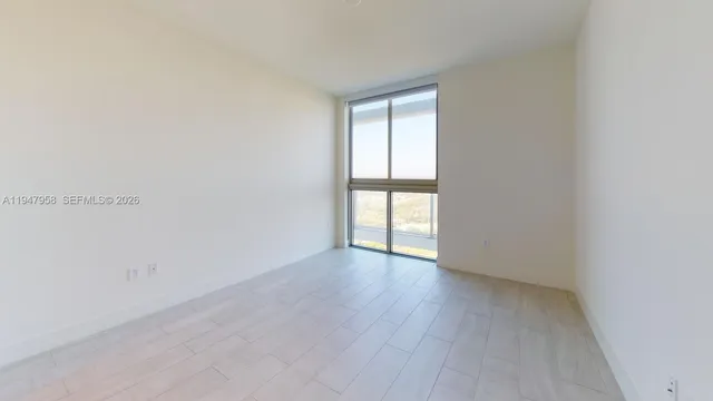 a view of an empty room and a window