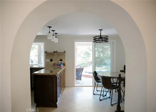 a kitchen with a table chairs and entryway