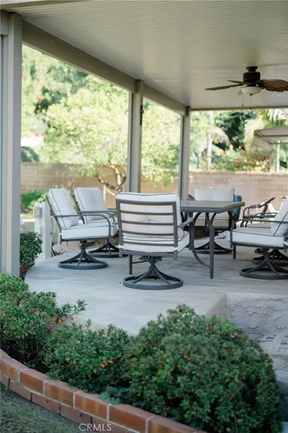 a building outdoor space with patio furniture and potted plants