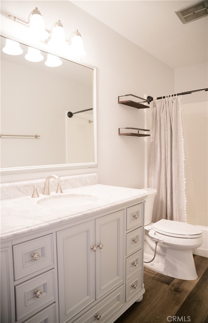 23035 Cecelia Mission Viejo, CA 92691 - Photo 20 of 30 a bathroom with a granite countertop sink a toilet and a mirror