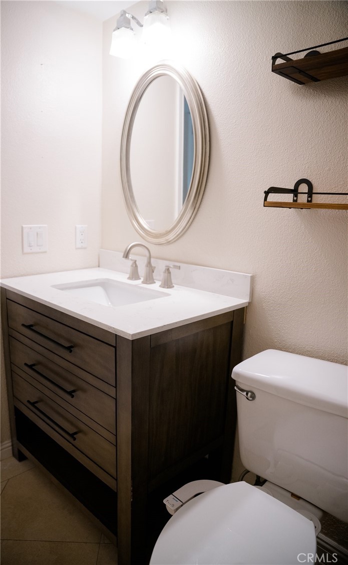 23035 Cecelia Mission Viejo, CA 92691 - Photo 26 of 30 a bathroom with a sink a toilet and a mirror
