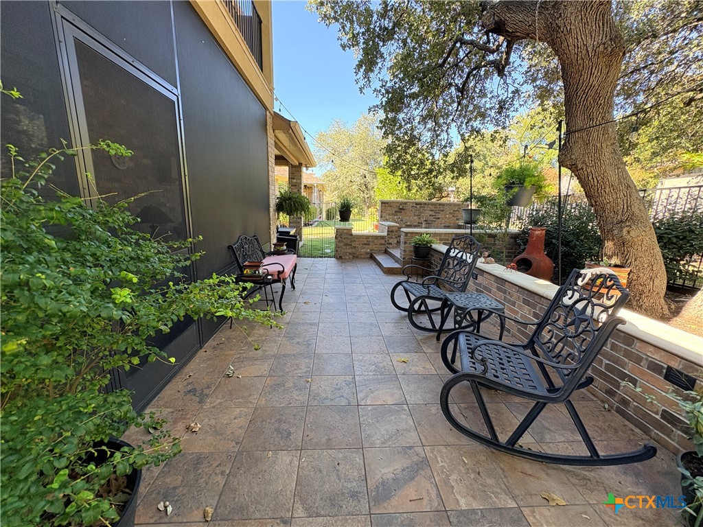 4802 Hidden Springs Trail Georgetown, TX 78633 - Photo 6 of 8 a view of a patio with couches and table and chairs next to a yard