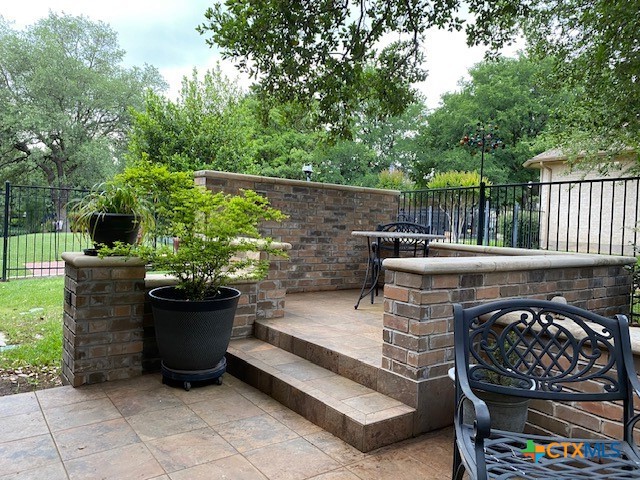 4802 Hidden Springs Trail Georgetown, TX 78633 - Photo 8 of 8 a view of a patio with chairs and a potted plant